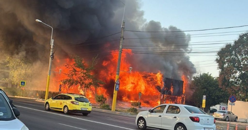 Imaginea prezintă incendiul devastator de la fostul Club Bellagio din Mamaia, cu flăcări și fum intens, ilustrând amploarea intervenției pompierilor.